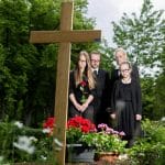 A Family Posing In Front Of A Cross, Navigating Grief And Remembering Love