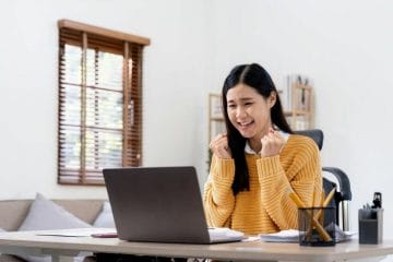 Asian Woman Working On A Laptop At Home.